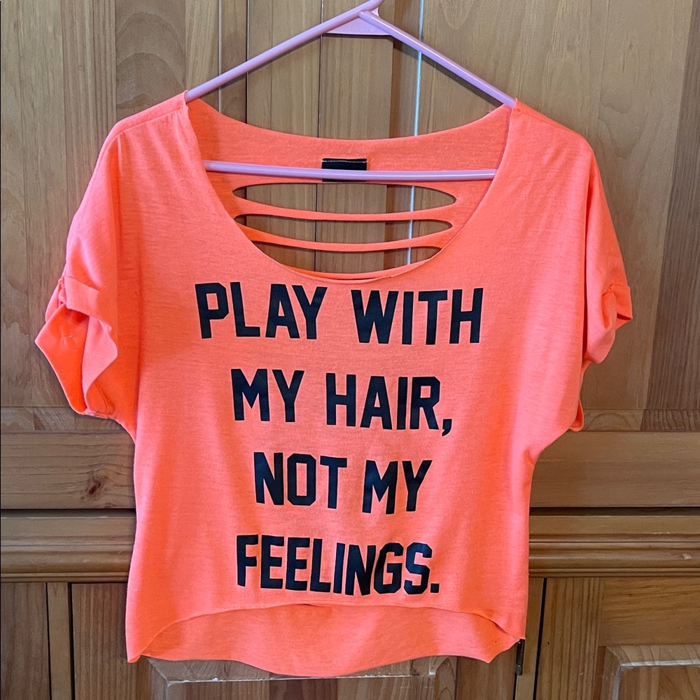Rue21 Orange Top-back open slits.Says "Play with my hair,not my feelings" Small.
